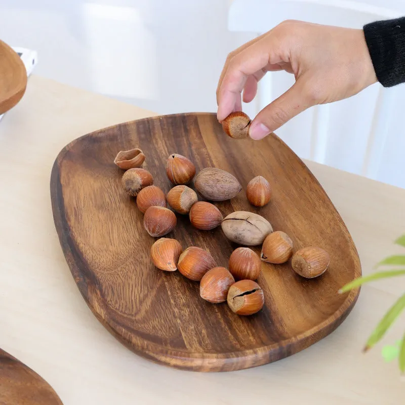 Acacia Japanese snack plate hand-polished natural wood with visible grain and mineral lines on a flat surface