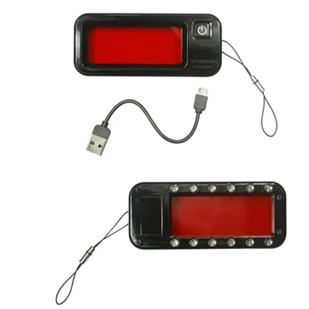Small red handheld reverse camera detector with scanner for finding hidden surveillance lenses.
