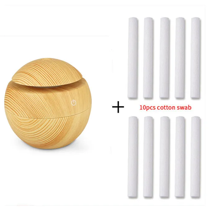 Mini USB aroma diffuser humidifier with wood grain finish, one fog outlet, and mechanical controls on a white background