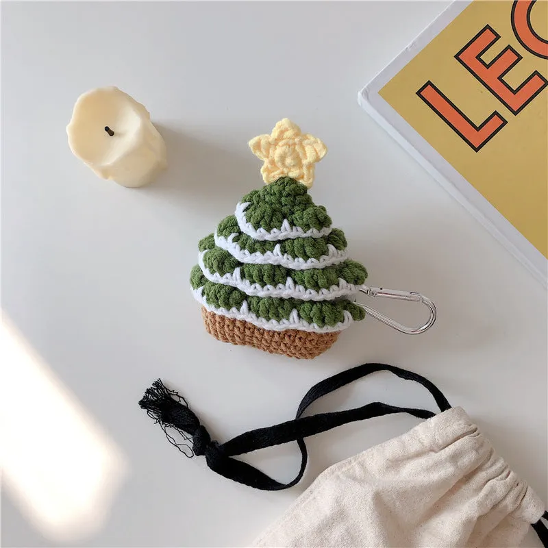 Green knitted Christmas tree flip-style headset case for AirPods with silver hook on white background