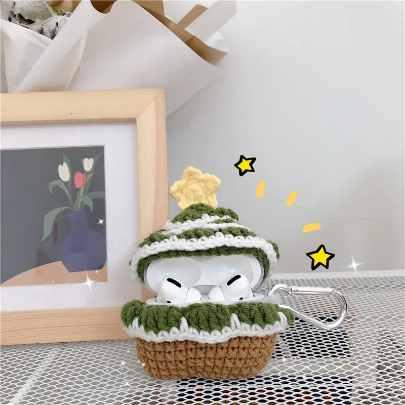 Green knitted Christmas tree flip-style headset case for AirPods with silver hook on white background