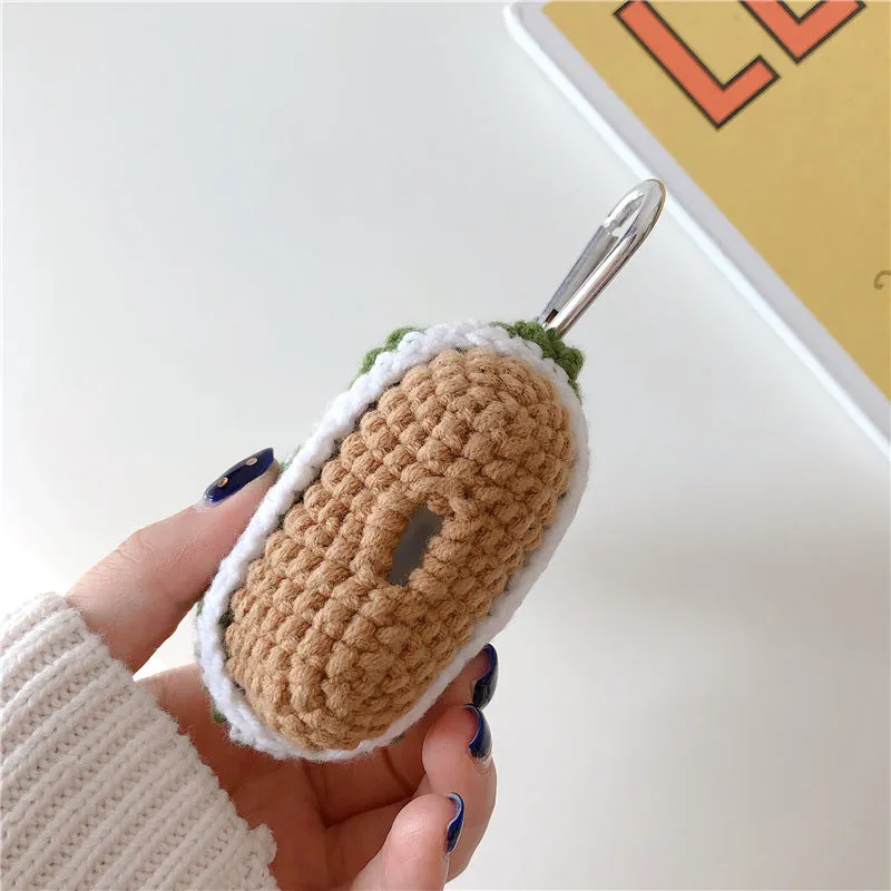 Green knitted Christmas tree flip-style headset case for AirPods with silver hook on white background