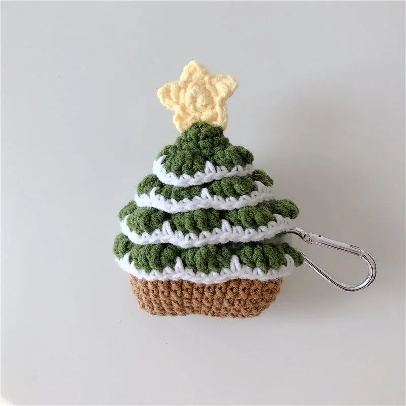 Green knitted Christmas tree flip-style headset case for AirPods with silver hook on white background