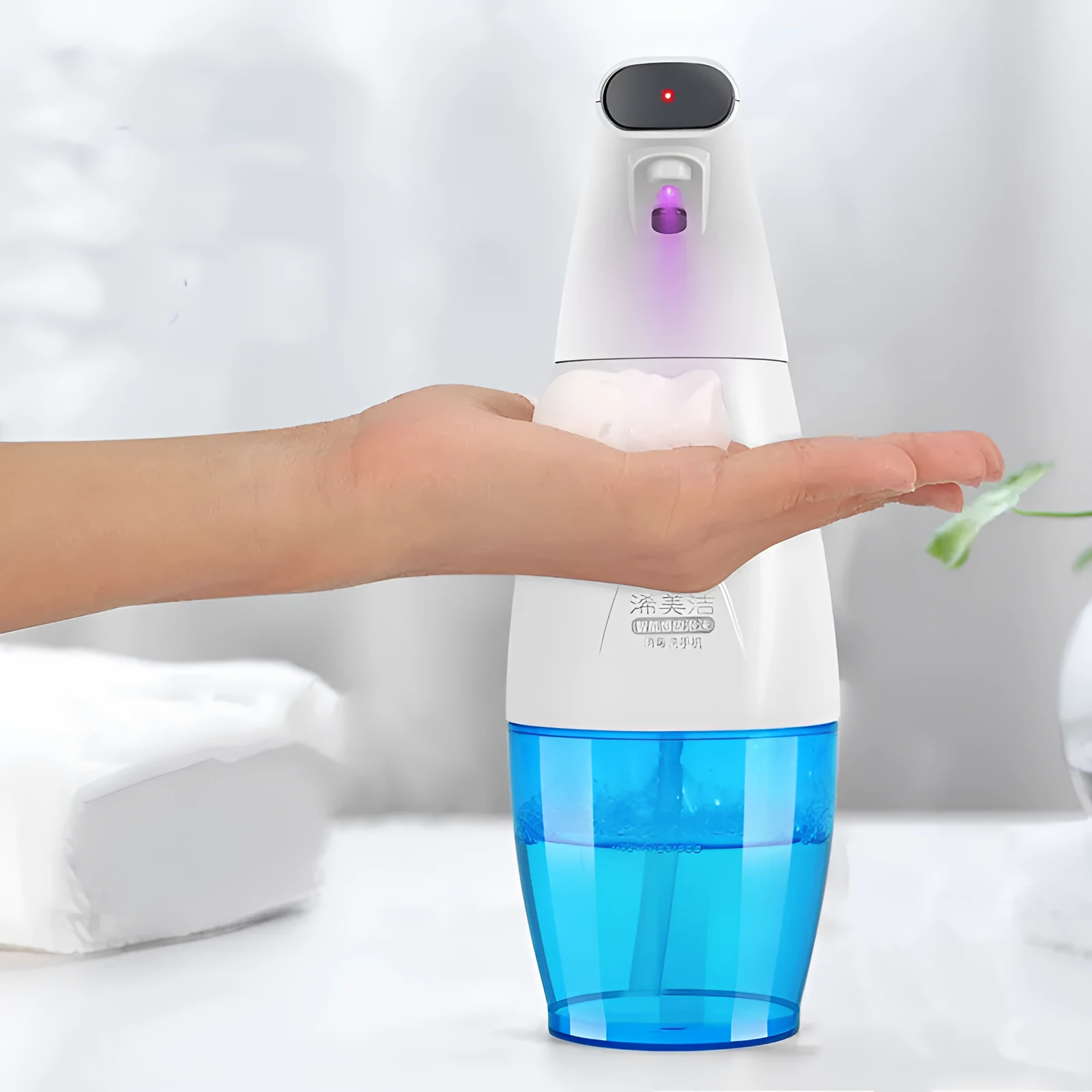 White intelligent induction foam machine on countertop with hand under nozzle dispensing foam