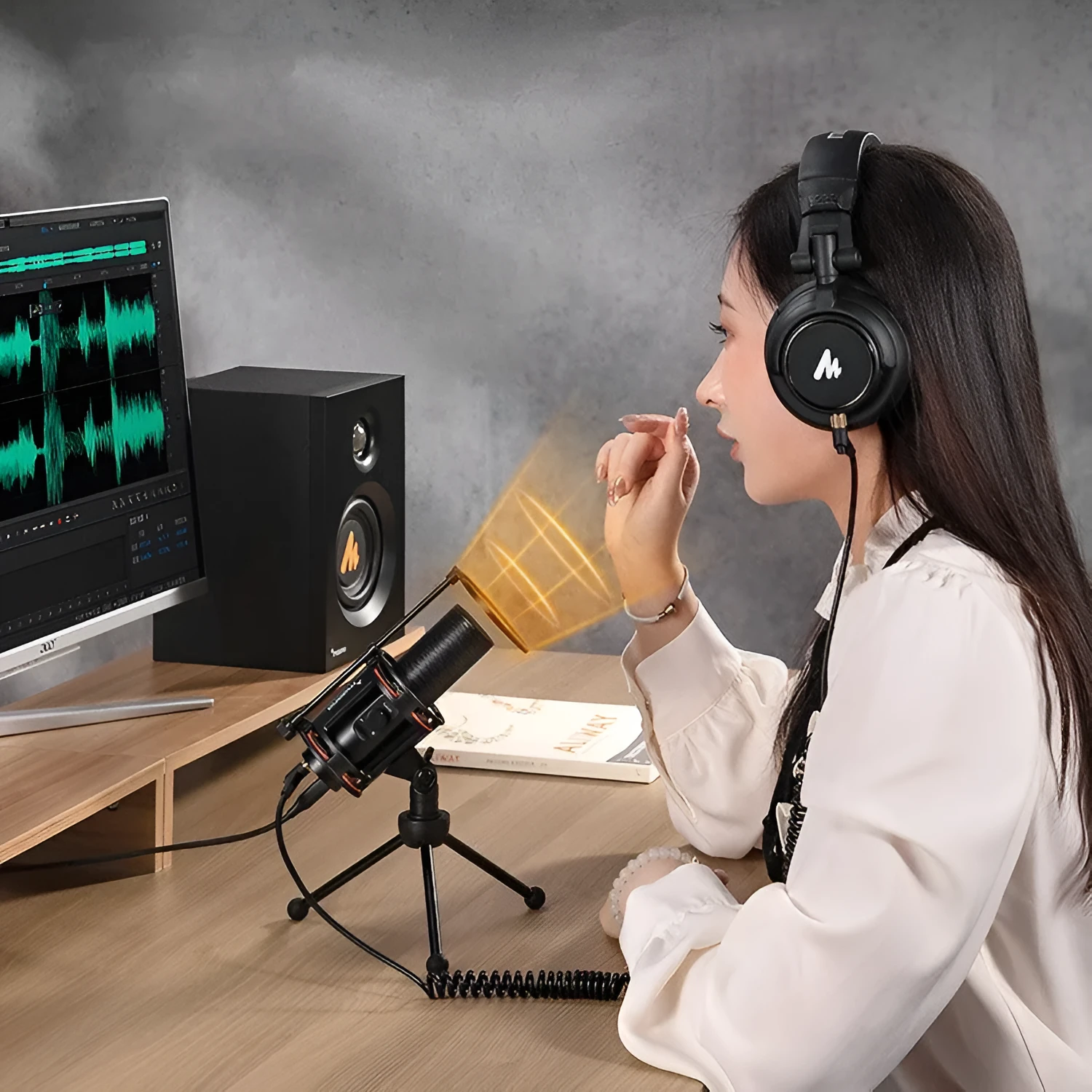 Black metal USB condenser recording microphone with 14mm diaphragm on desk with cable