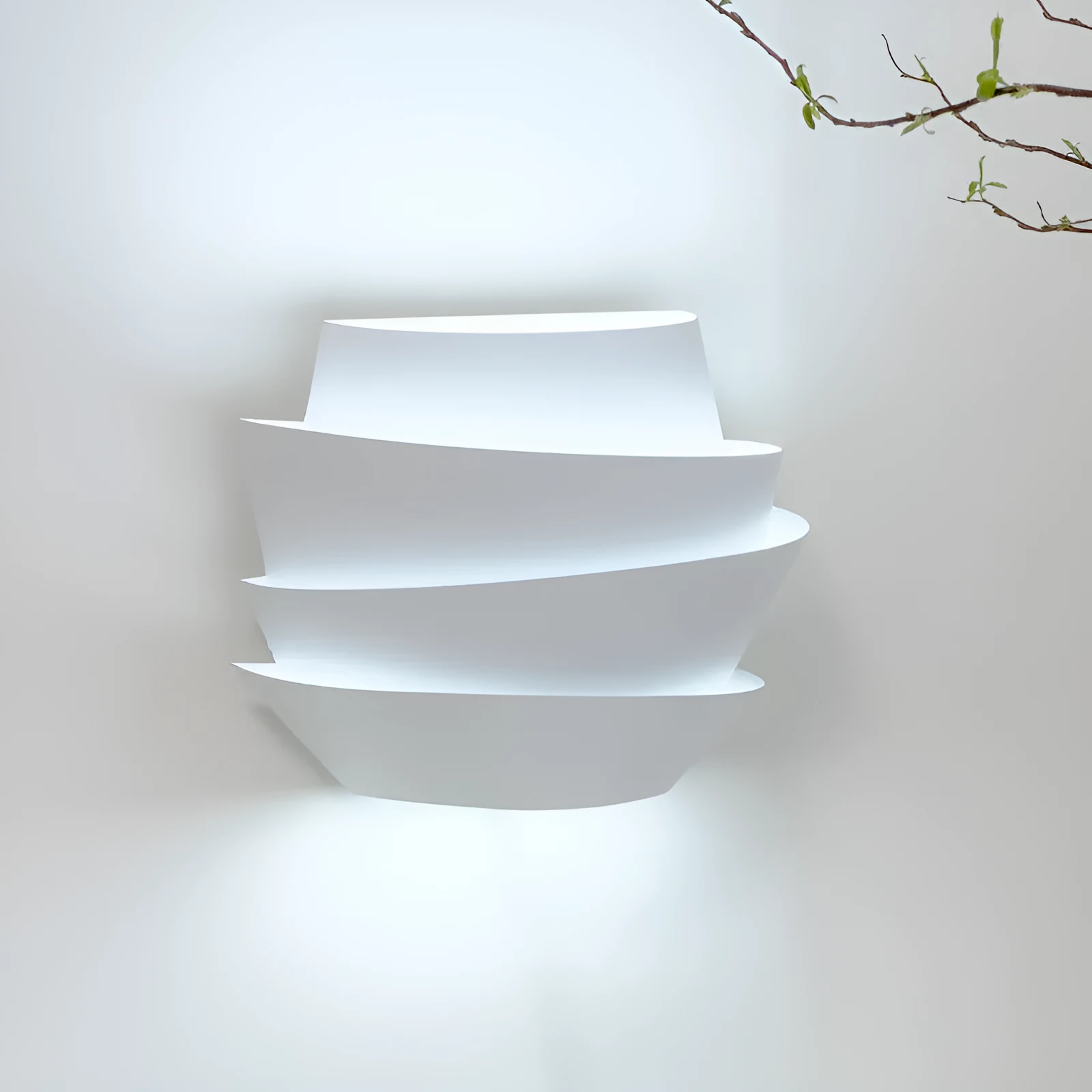 Modern white wall lamp with pine cone decoration mounted on a plain wall.