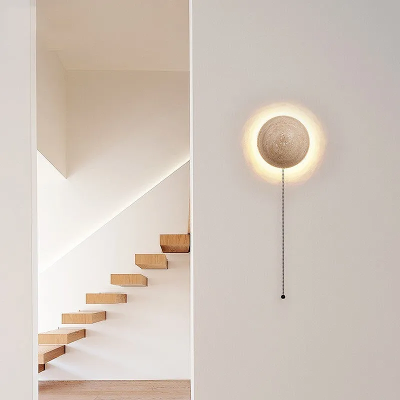 Yellow semicircle cave stone wall lamp with wooden fixture mounted on a wall.