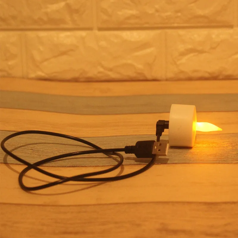 White plastic USB rechargeable LED candle lamp with flame-shaped head on plastic cup