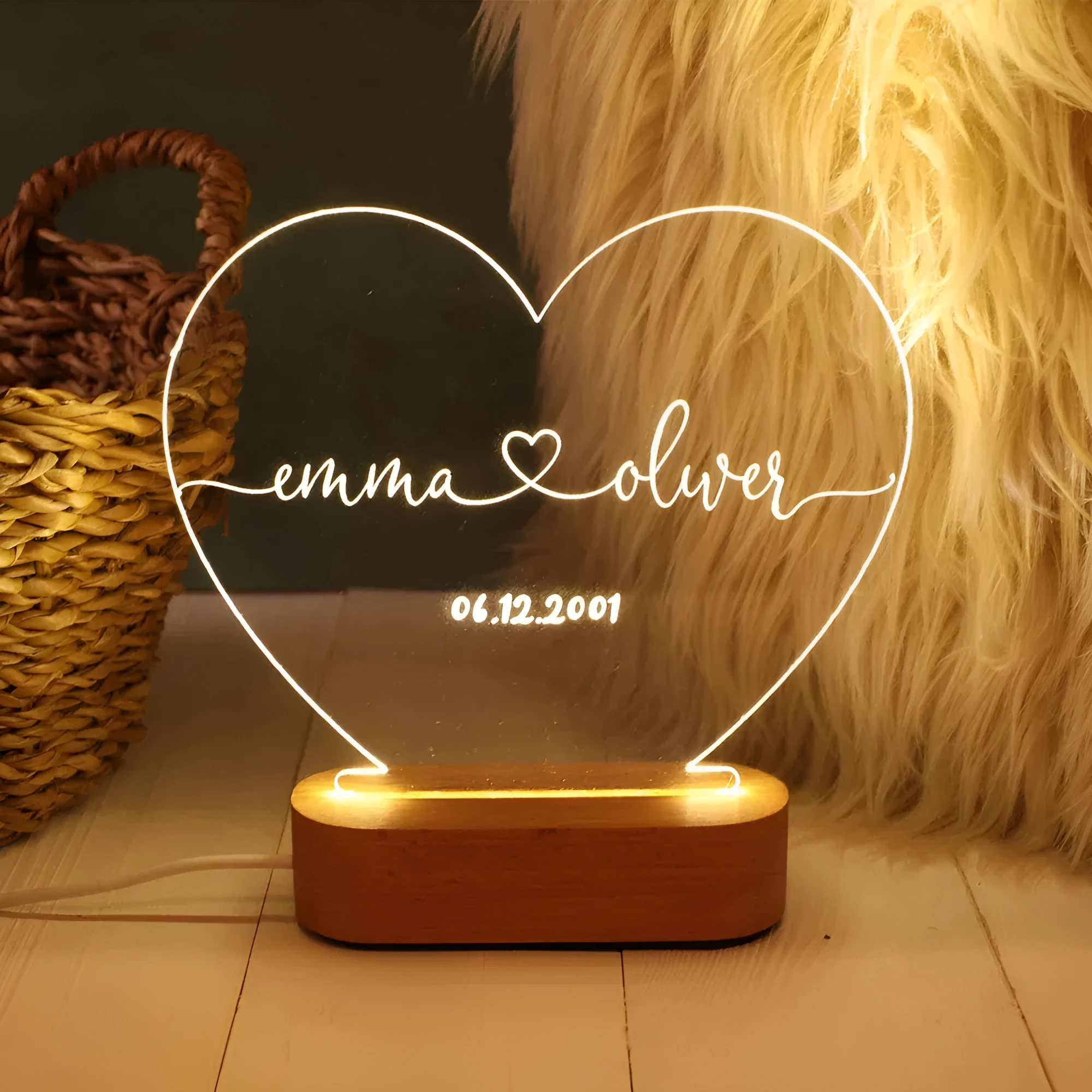 Custom acrylic night light with engraved names and date, lit by LED base.