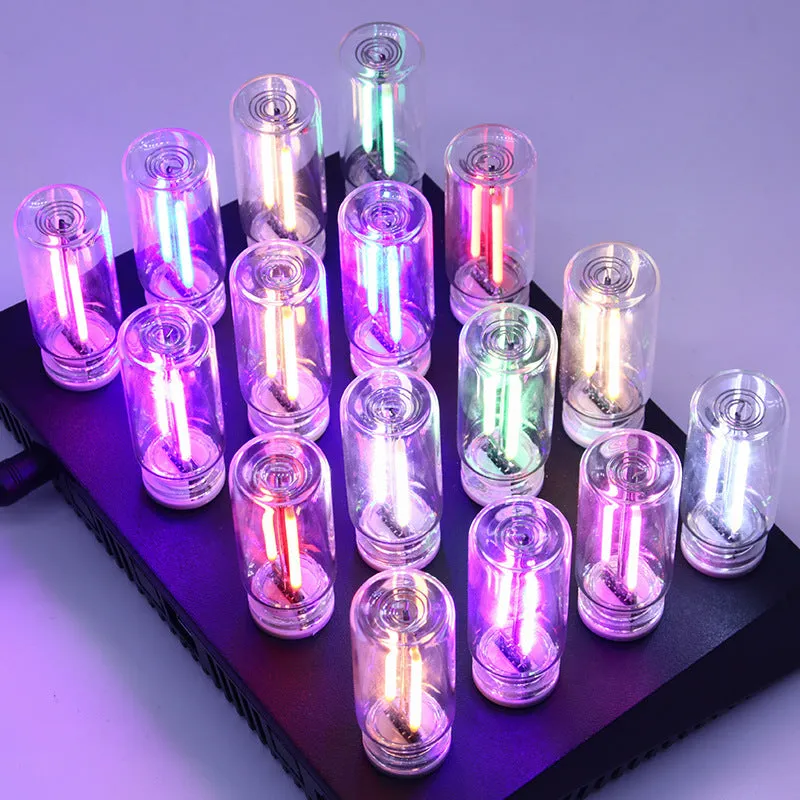 Small transparent glass USB touch night lamp with warm white light on a desk
