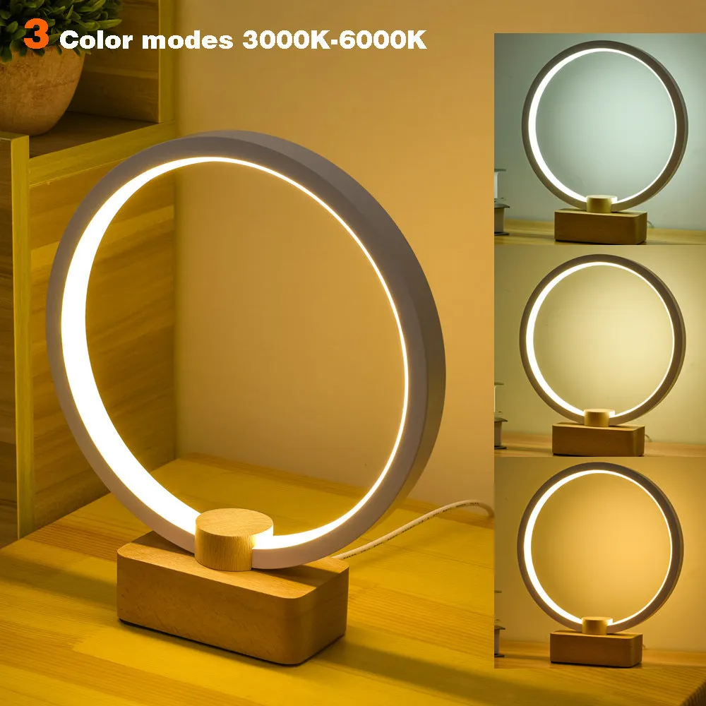 Round small solid wood and bamboo USB-powered LED night lamp on a table.