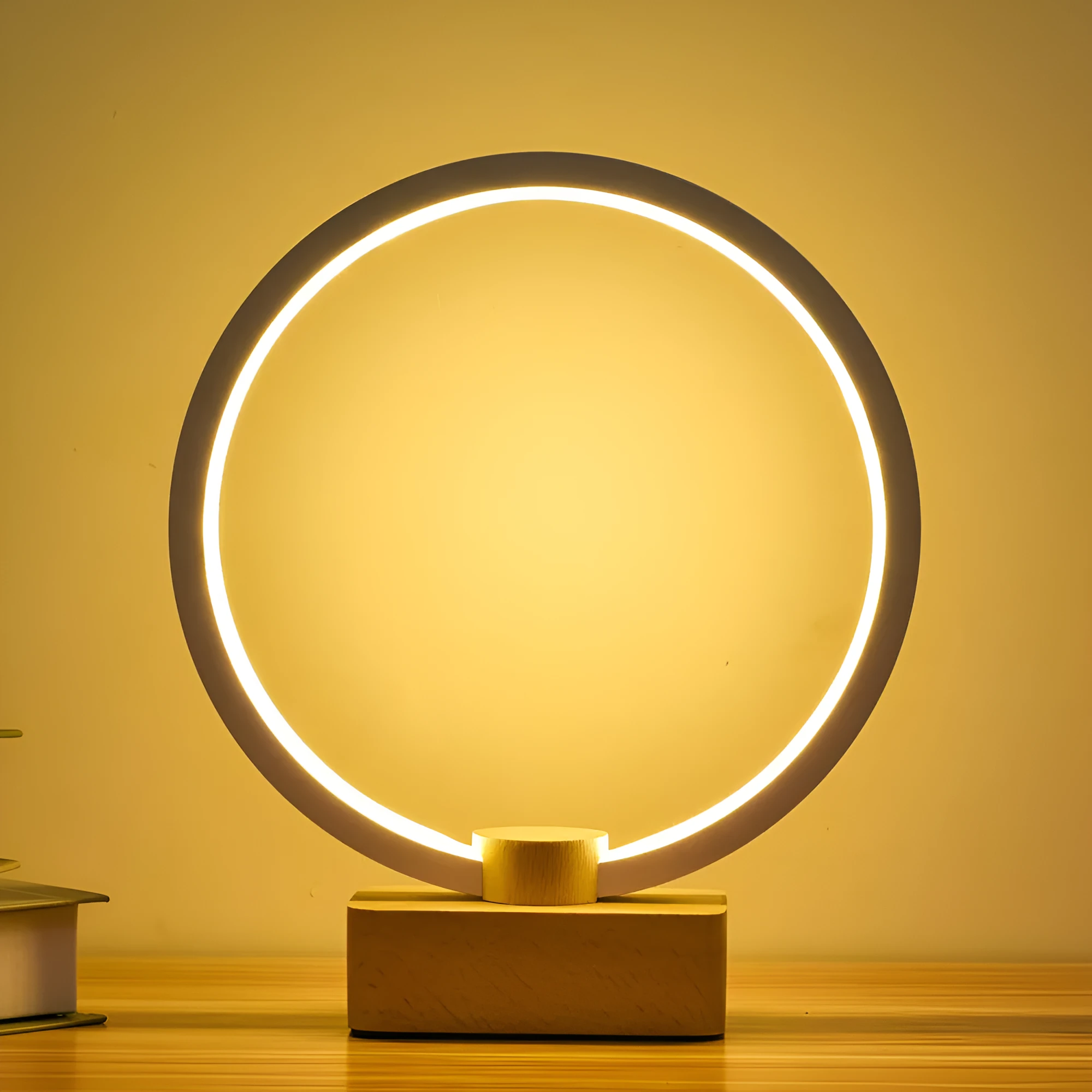 Round small solid wood and bamboo USB-powered LED night lamp on a table.