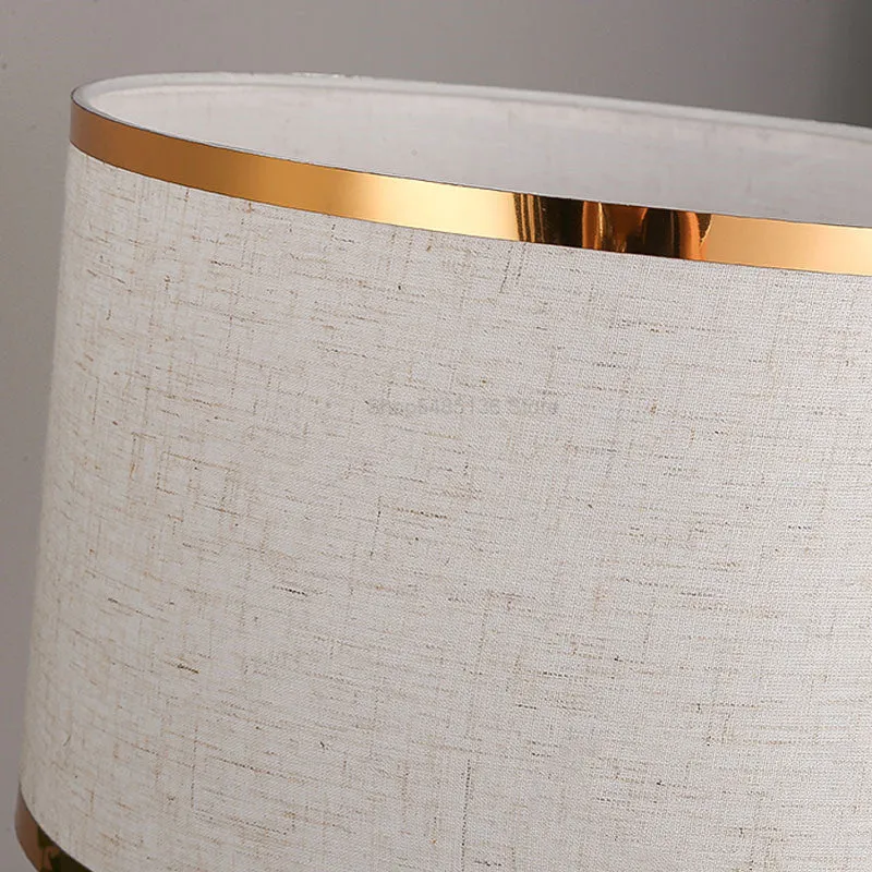 Desk lamp with iron base and fabric shade in choice of black, gold or white colours