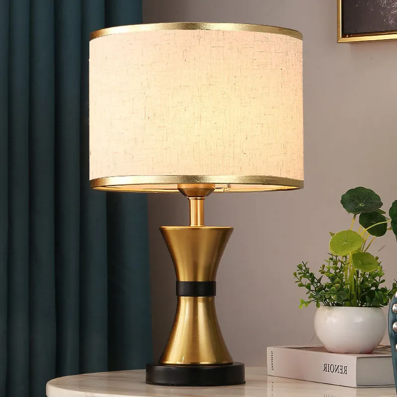 Desk lamp with iron base and fabric shade in choice of black, gold or white colours