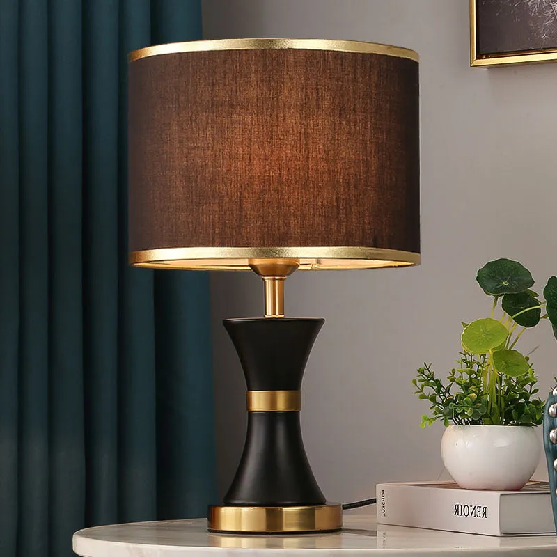 Desk lamp with iron base and fabric shade in choice of black, gold or white colours