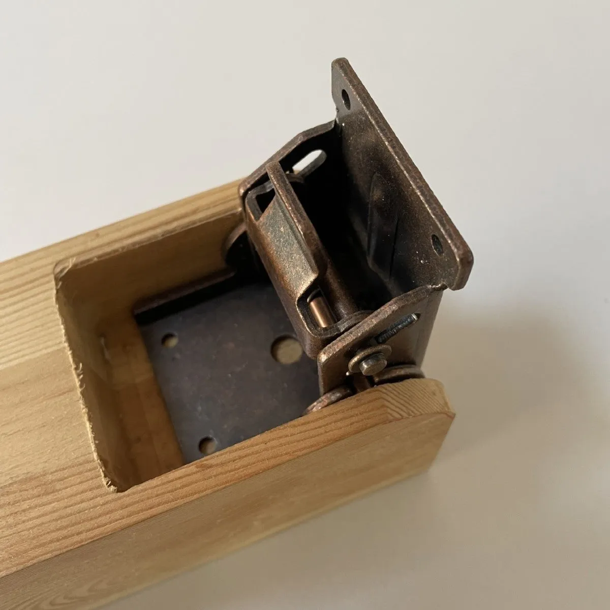 Metal self-locking folding hinge for furniture cabinets and wardrobes in various electroplated finishes.