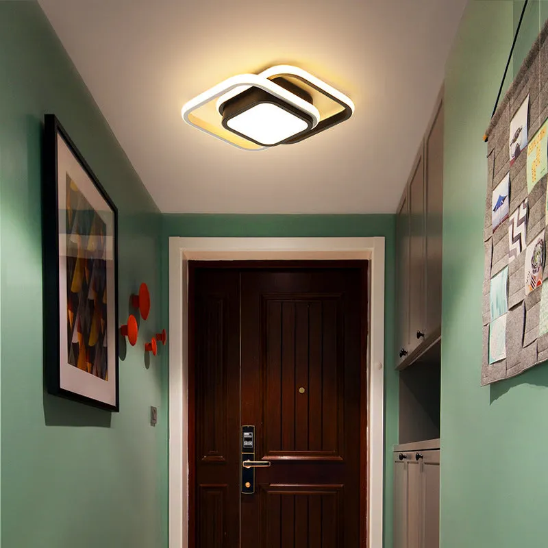 Modern round aluminium ceiling light with integrated LEDs, shown illuminating an entrance hall.