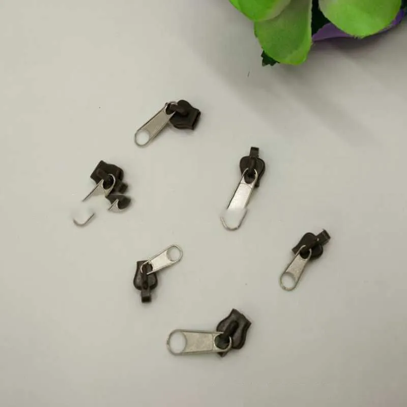Reusable zipper head repair kit with 12 plastic and metal sliders in black, black grey, and coffee brown colours