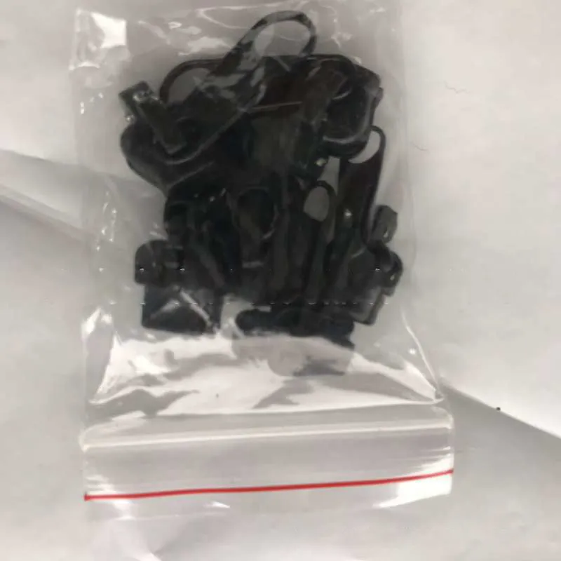 Reusable zipper head repair kit with 12 plastic and metal sliders in black, black grey, and coffee brown colours