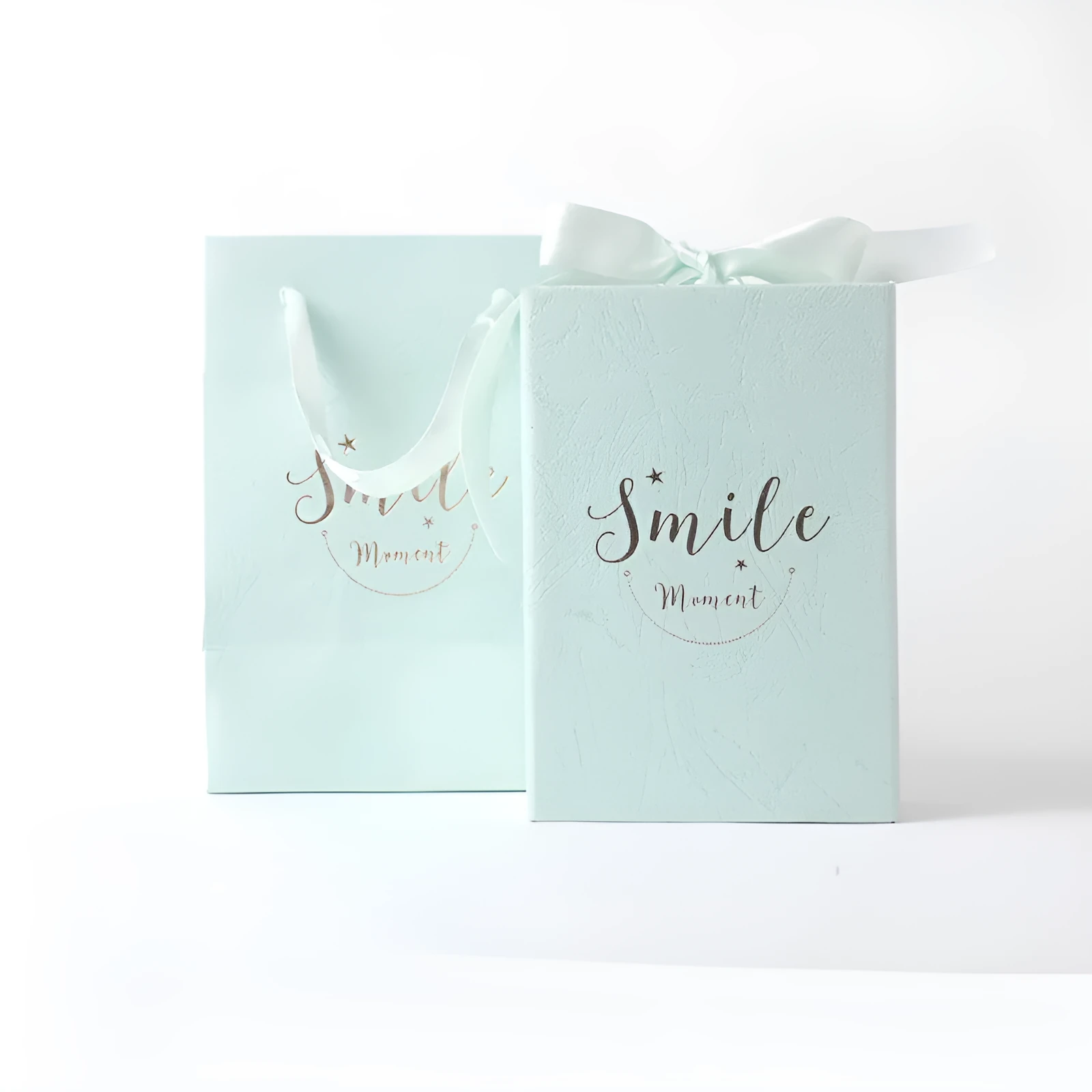 Small hard cardboard gift box with bronzing detail in blue, pink, red, and white colour options