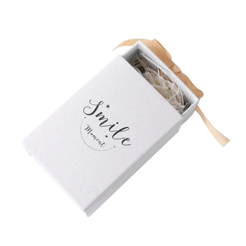Small hard cardboard gift box with bronzing detail in blue, pink, red, and white colour options