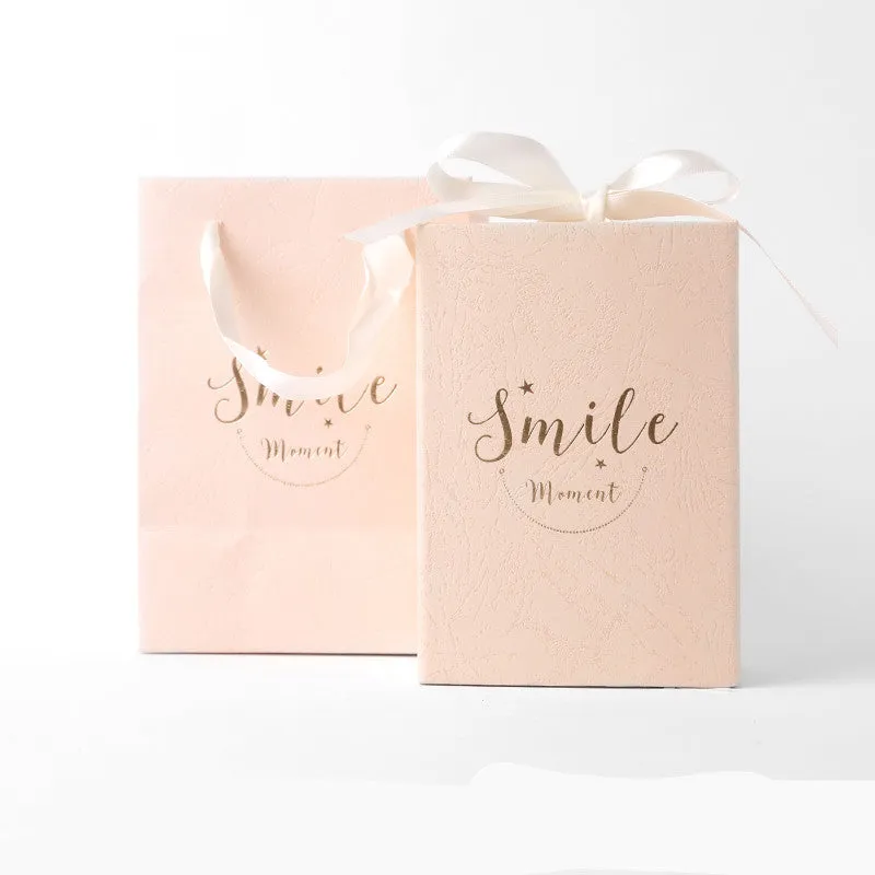 Small hard cardboard gift box with bronzing detail in blue, pink, red, and white colour options