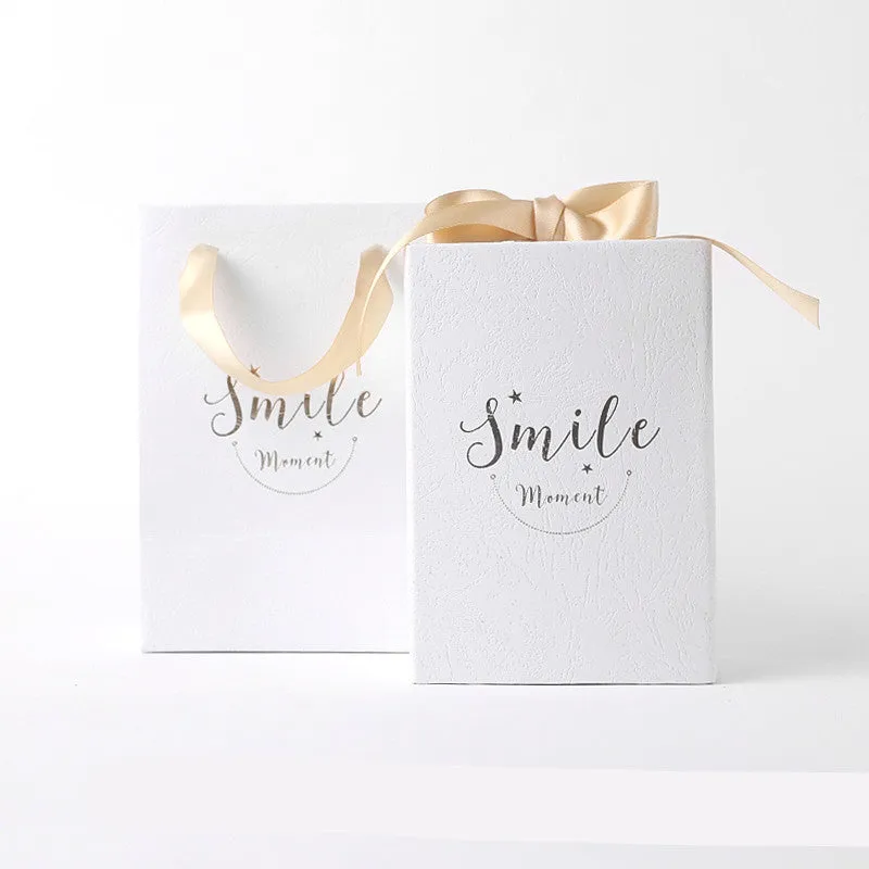 Small hard cardboard gift box with bronzing detail in blue, pink, red, and white colour options
