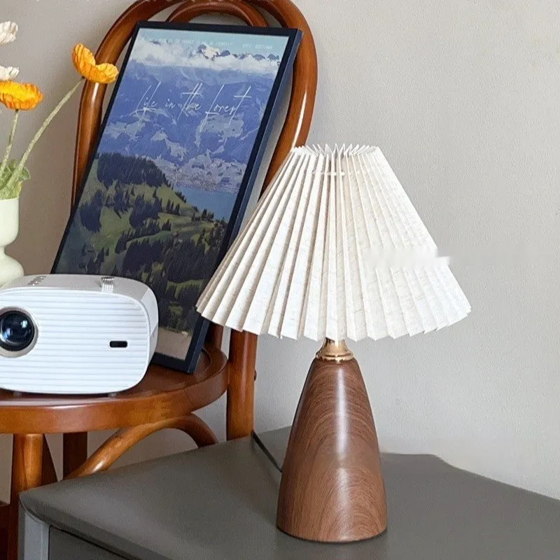 Nordic retro ceramic table lamp with pleated floral shade and remote control on a wooden bedside table.