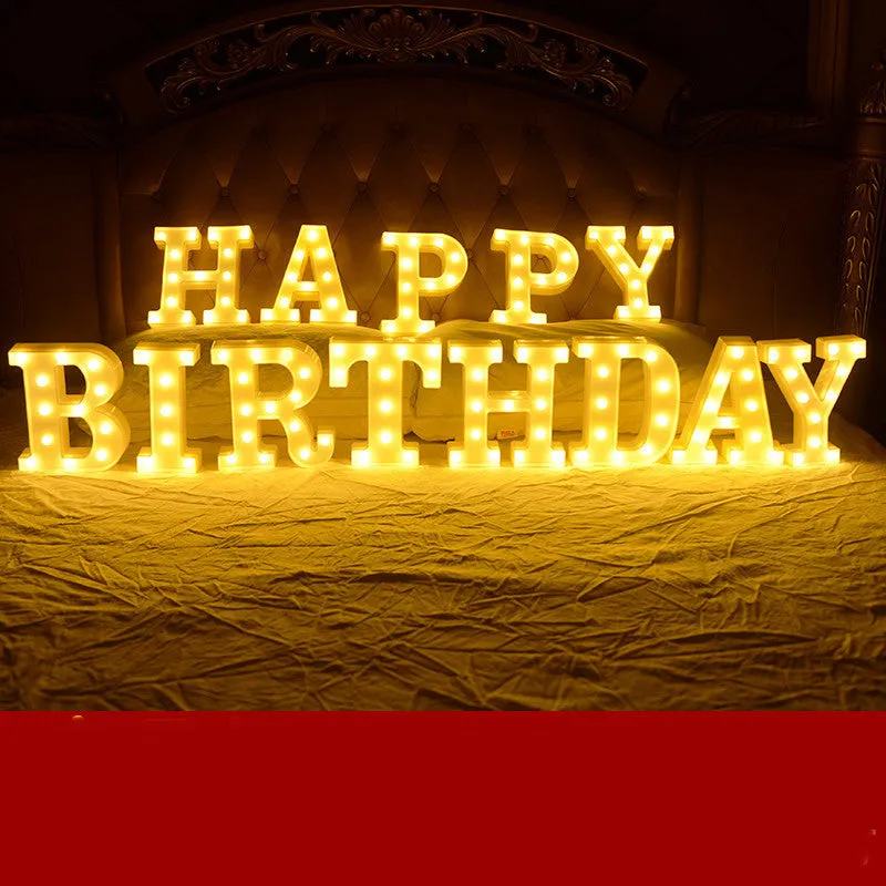 Plastic LED letter light decoration spelling a message, 22cm in height.