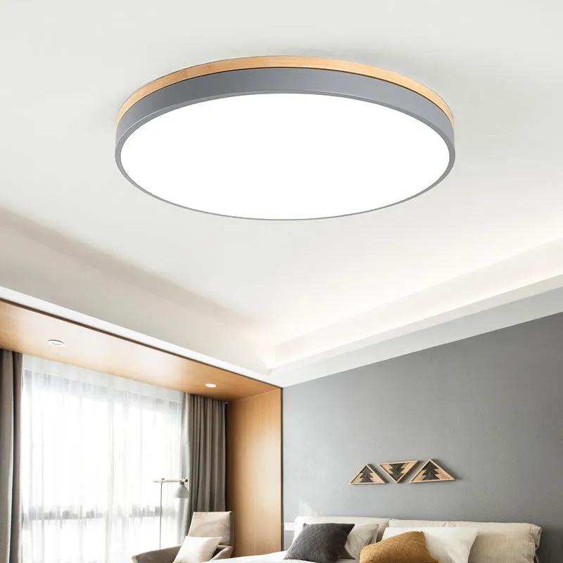 Round Nordic style ceiling lamp with solid wood and iron frame, white acrylic diffuser, shown in a living room setting.