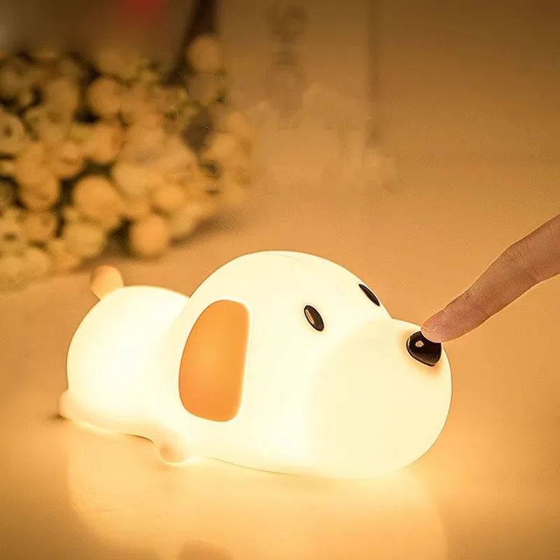 Silicone cartoon dog night lamp in two colours with a USB charging cable.