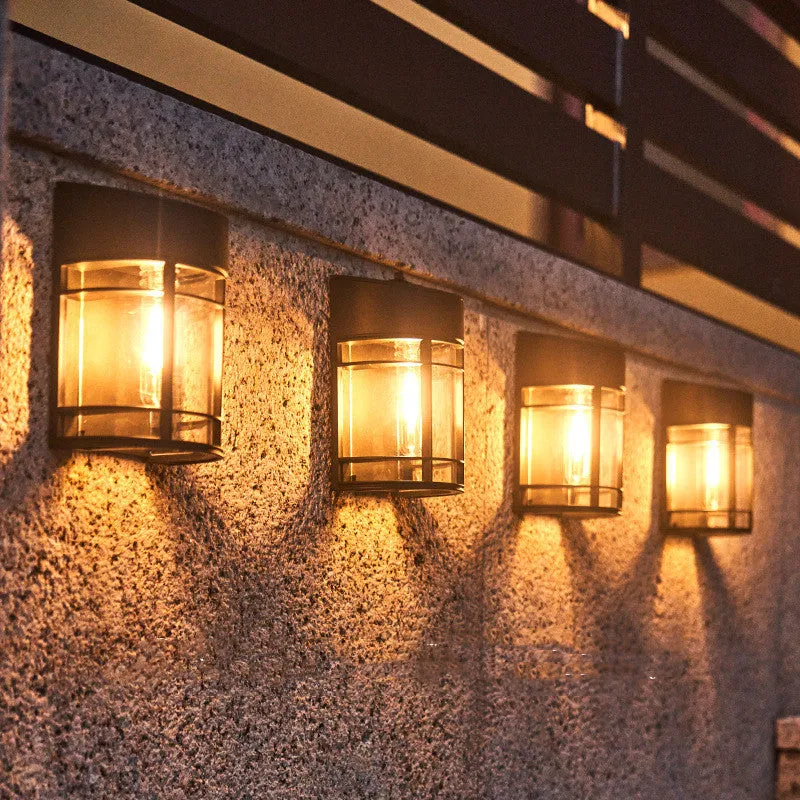 Set of 6 solar-powered outdoor wall lights with warm white illumination mounted on a garden wall