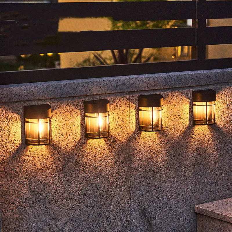 Set of 6 solar-powered outdoor wall lights with warm white illumination mounted on a garden wall