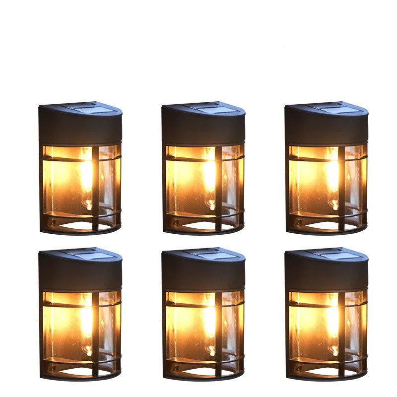 Set of 6 solar-powered outdoor wall lights with warm white illumination mounted on a garden wall