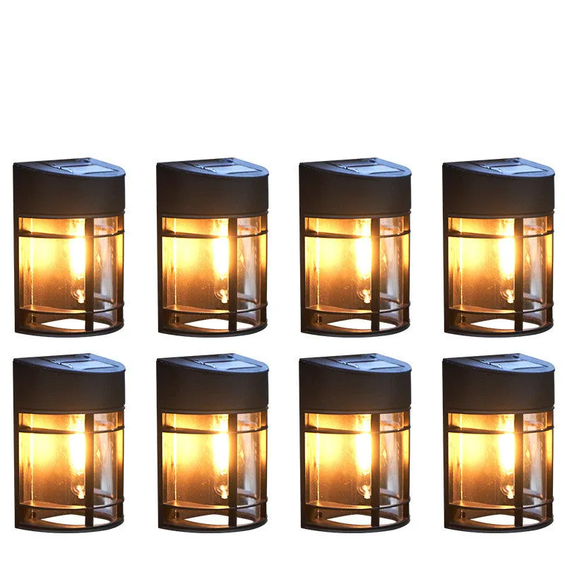 Set of 6 solar-powered outdoor wall lights with warm white illumination mounted on a garden wall