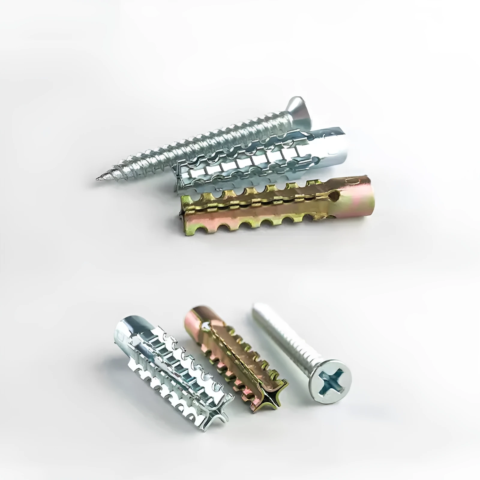 Metal expansion tube and screw set with serrated barbs for wall fixing in concrete and brick