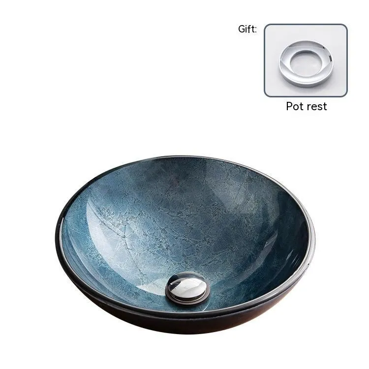 Blue grey coloured tempered glass bathroom table basin with simple art design on a countertop.