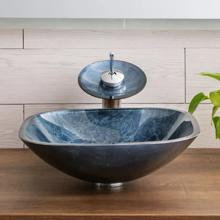 Blue grey coloured tempered glass bathroom table basin with simple art design on a countertop.