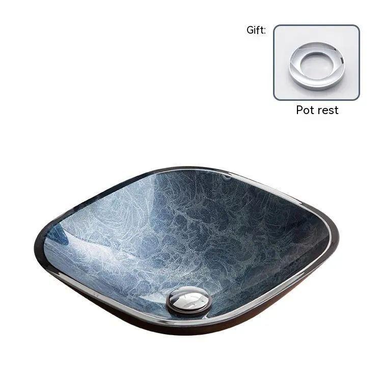 Blue grey coloured tempered glass bathroom table basin with simple art design on a countertop.