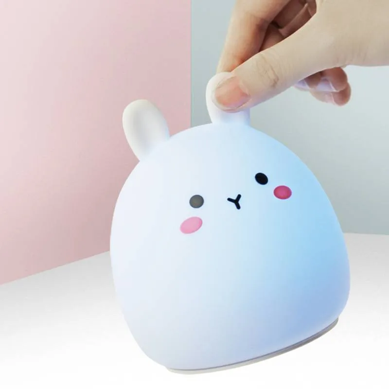 Silicone cute rabbit rechargeable night light with LED glow on bedside table