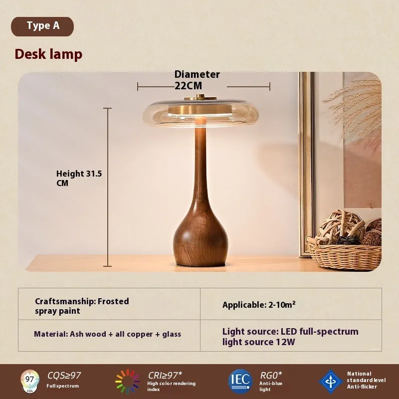 Solid ash wood bedside lamp with cognac shade and metal base on wooden table
