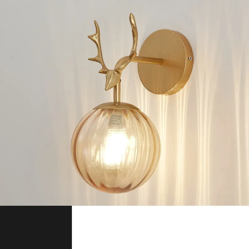 Round minimalist glass wall sconce with E27 bulb holder, shown in a black and golden finish, mounted on a plain wall.