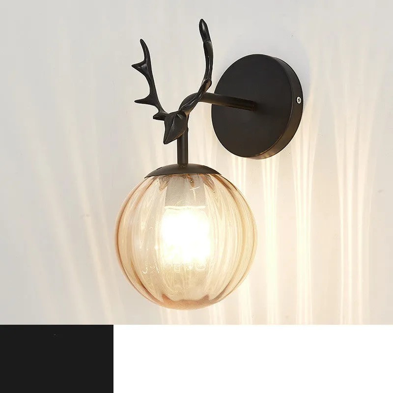 Round minimalist glass wall sconce with E27 bulb holder, shown in a black and golden finish, mounted on a plain wall.