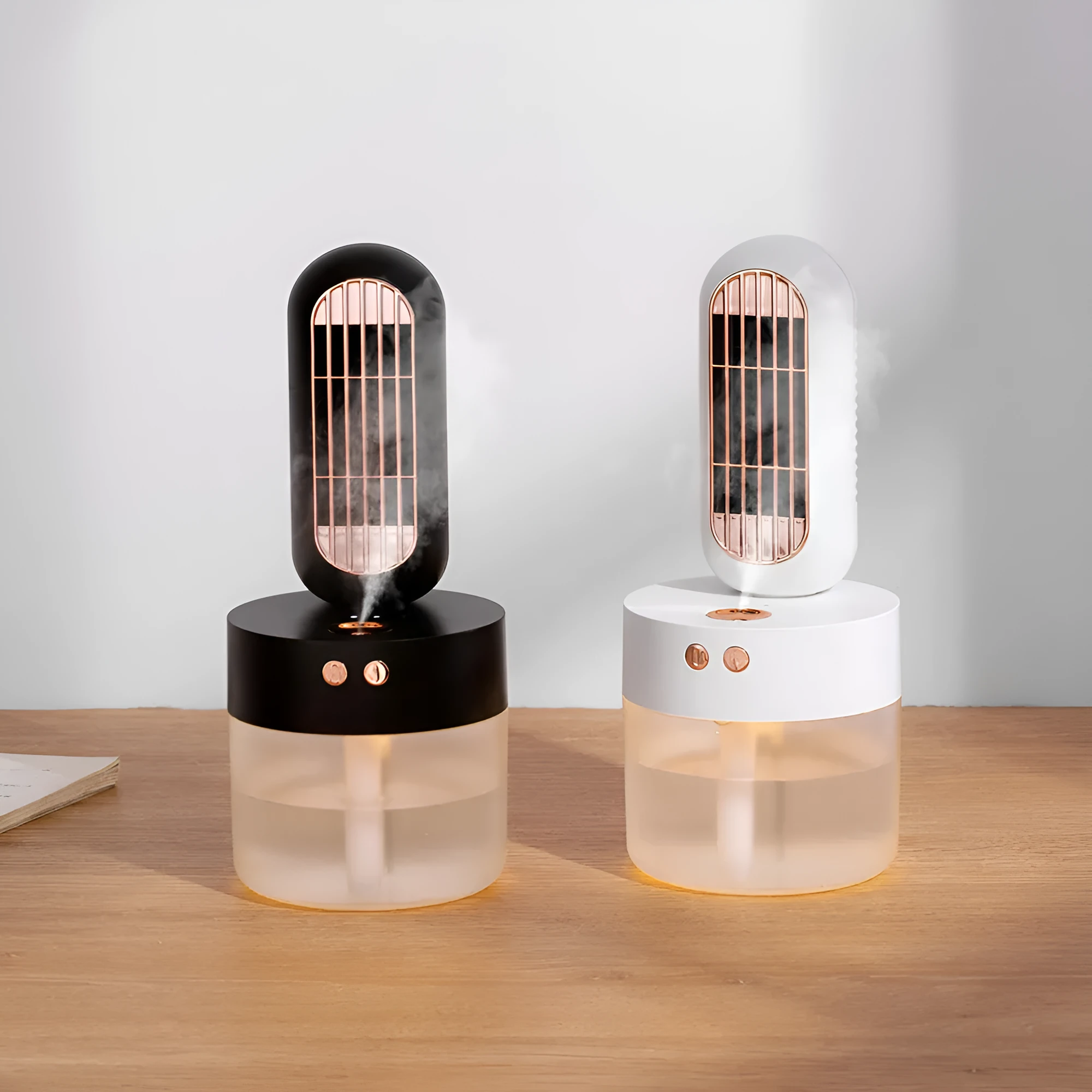 Small black and white portable humidifying desk fan with oscillating head on a table.
