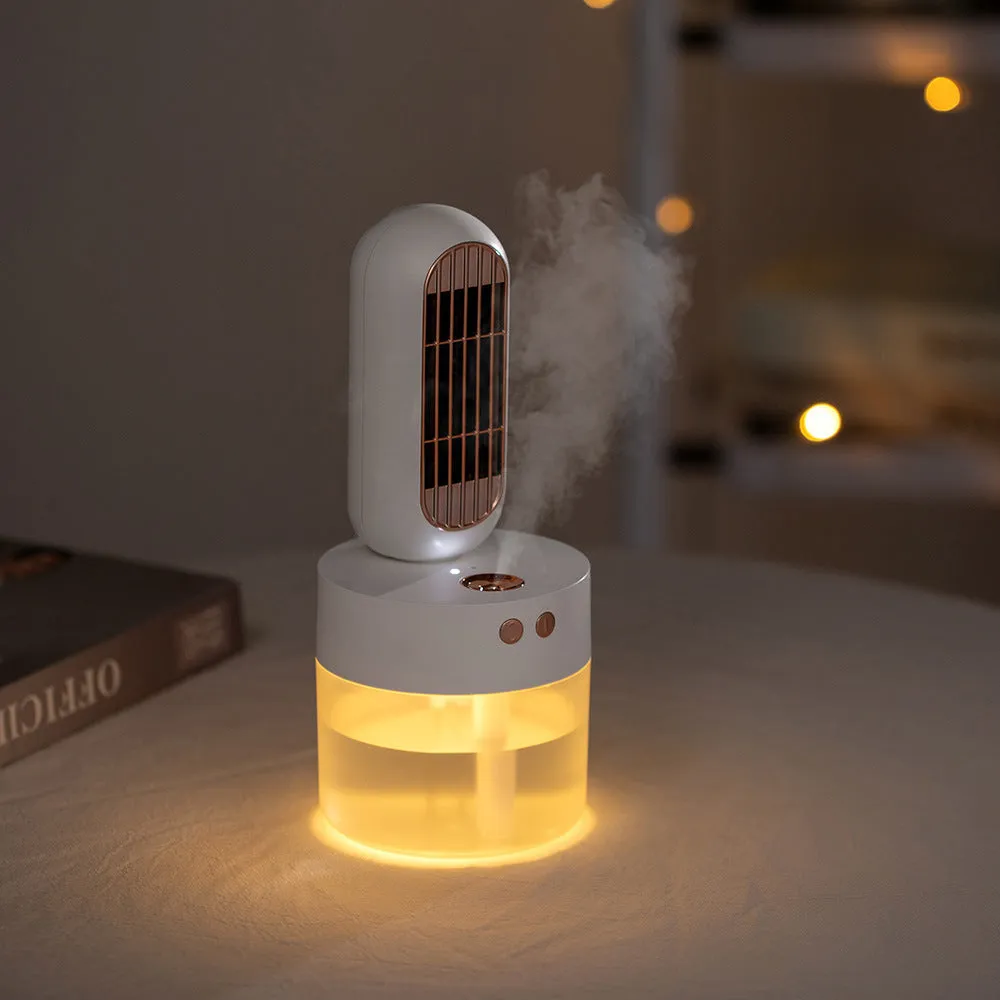 Small black and white portable humidifying desk fan with oscillating head on a table.