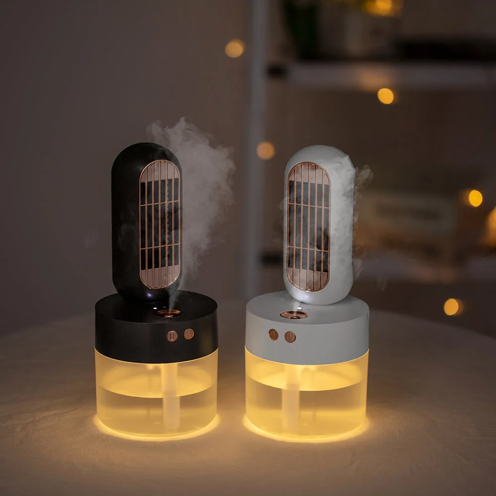 Small black and white portable humidifying desk fan with oscillating head on a table.