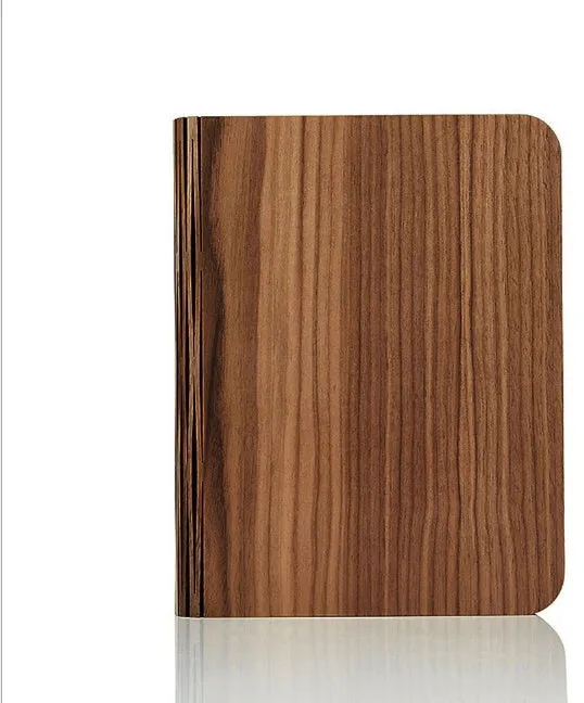 Solid wood USB-powered book light in three size options on a wooden table.
