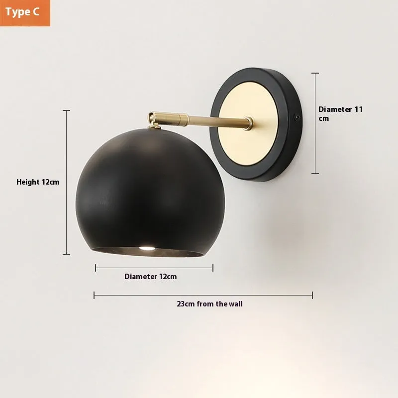 Nordic style iron wall lamp mounted on a wall, showcasing its welded shade design.