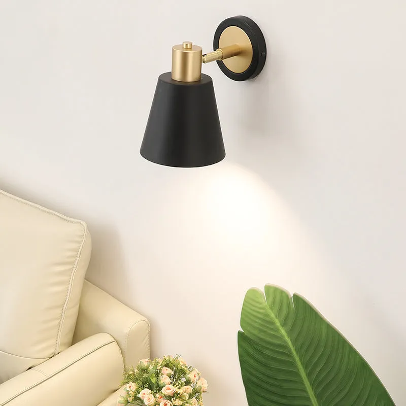 Nordic style iron wall lamp mounted on a wall, showcasing its welded shade design.