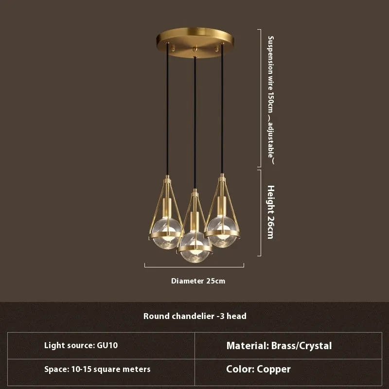 Modern copper and crystal chandelier with multiple light heads in a minimalist design.